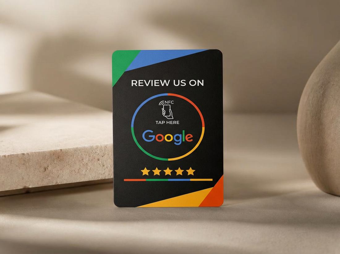 Matte black NFC Google review card with a lime tap symbol and five stars, on a warm bone surface.